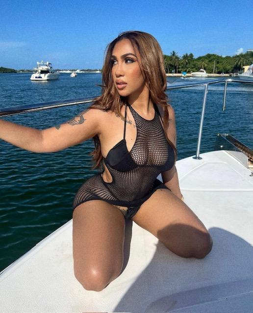 Queen Naija on a boat