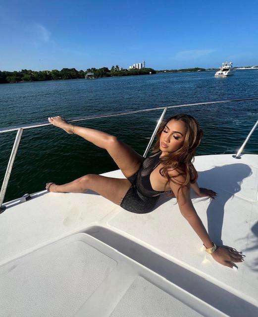 Queen Naija poses for photo on a boat